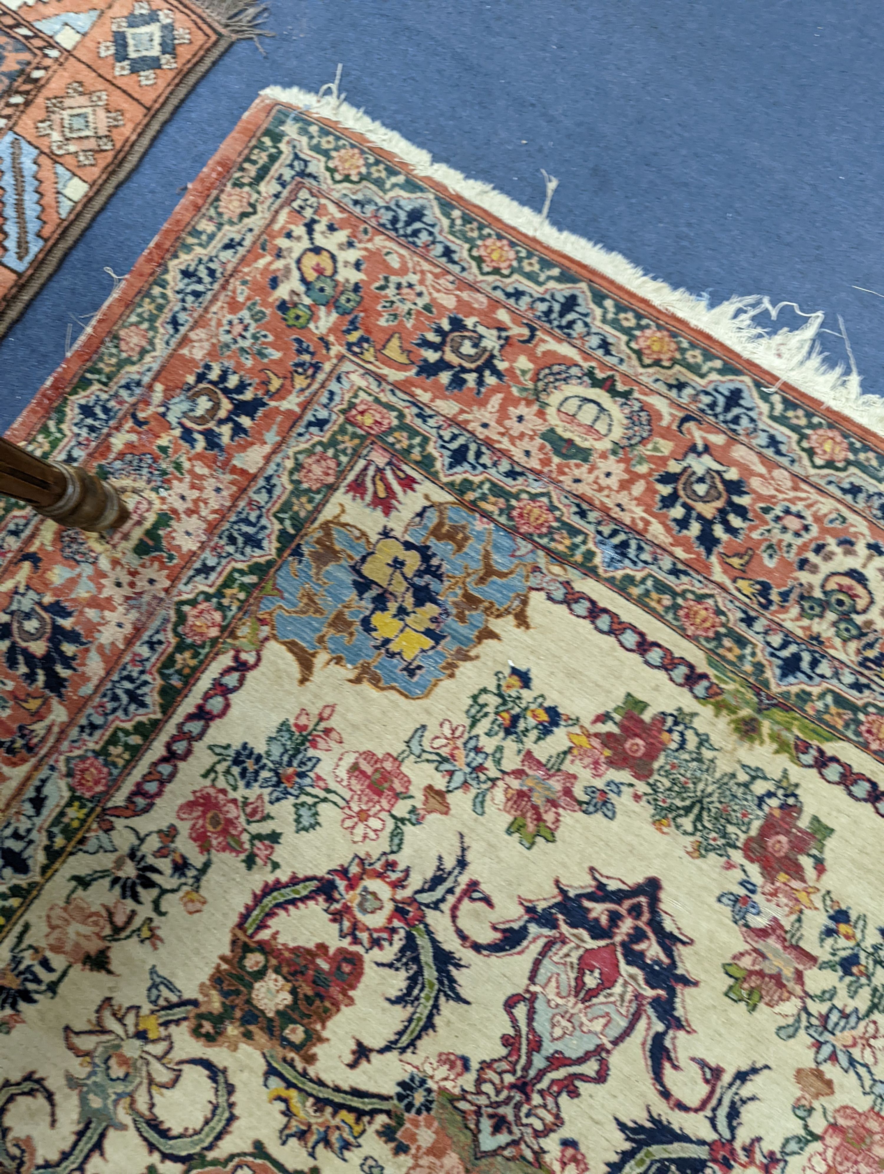 A part silk Isfahan cream rug with central floral scroll medallion, 196 x 140cm